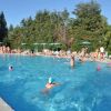 Piscina all'aperto con persone che nuotano.